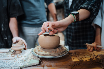Making a handmade clay pot. Pottery lesson with master.