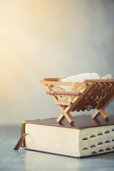 Christian Christmas concept. Birth of Jesus Christ. Wooden manger on Holy bible. Banner, copy...