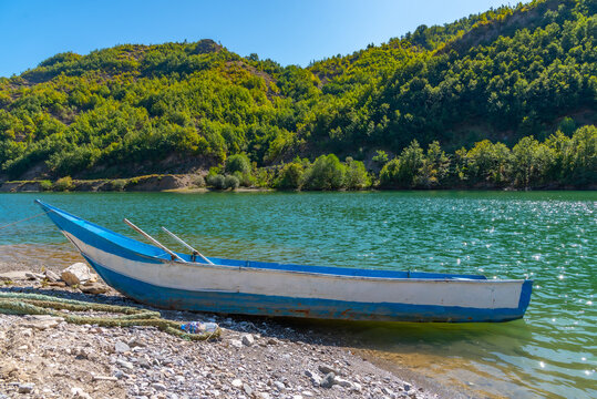 Wooden boats mooring at Komani ferry pier in Albania