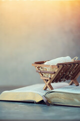 Obraz premium Birth of Jesus Christ. Wooden manger on Holy bible. Christian Christmas concept. Banner, copy space. Nativity scene symbol. Jesus is reason for season. Salvation, Messiah, Emmanuel, God with us, hope