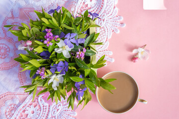 flower arrangement on a pink background with a cup of coffee. Concept healthy breakfast.