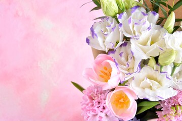 Beautiful spring flowers on pink background, selective focus, copy space. Bunch of tender tulips, eustoma flowers and hyacinthus. Romantic bouquet of flowers. 