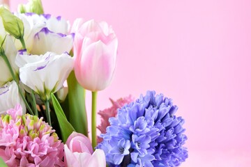 Beautiful spring flowers on pink background, selective focus, copy space. Bunch of tender tulips,...