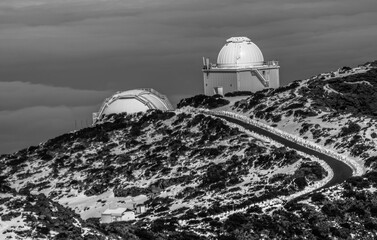 Two buildings of the observatory on the Canary Island La Palma. A road leads to the building. The...