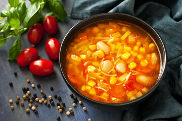  Ceramic bowl of minestrone soup on dark background