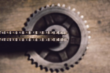 Two gears on a wooden background