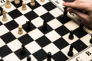 Hand with a chess piece. Game of chess
