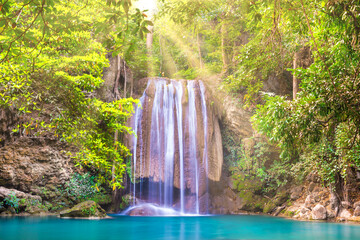 Beautiful waterfall and emerald lake in green tropical jungle forest. Nature landscape of Erawan...
