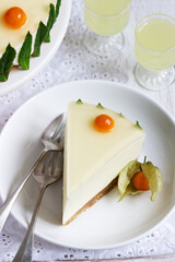 Mousse cake with cream, condensed milk and lime juice, garnished with jelly and physalis, served with limoncello.