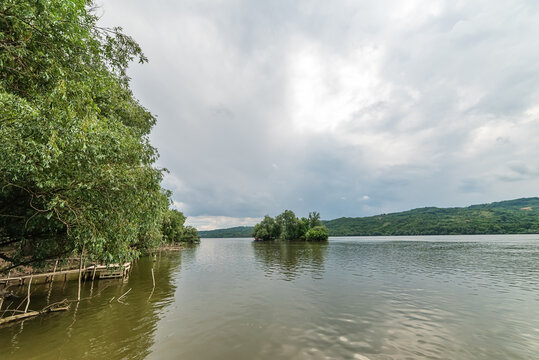 An island on the Danube. River island in the Danube, under the cloudy sky