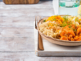 Vegan quinoa bowl with baked spiced pumpkin, fennel, bell pepper and turmeric. Healthy gluten free lunch or dinner