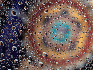 Colorful water droplets reflect flowers and shapes