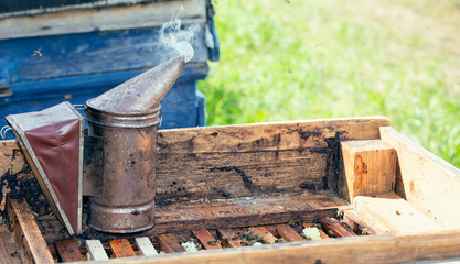 Chimney for flashing bees. The tool of the beekeeper. Bee smoker smokes