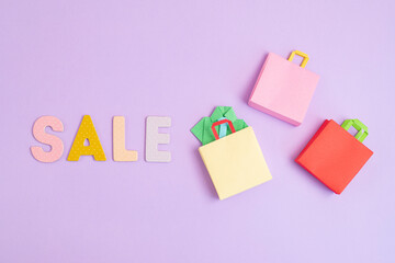 Word Sale and shopping paper bags. Sesonal sale, online deals, discounts, promotion, shopping addiction idea