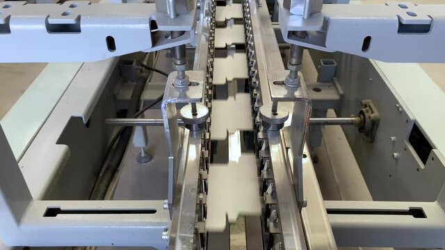 Printing press gluer in operation. Industry concept.