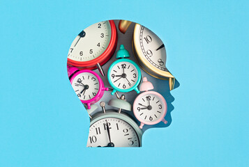 Papercut head filled with alarm clocks. Modern lifestyle, stress, time management, planning idea