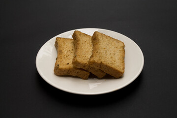 Toasts in a white plate on a black background