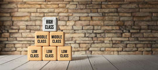 Fototapeta na wymiar cubes with message HIGH CLASS, MIDDLE CLASS, LOW CLASS in front of brick wall