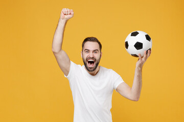 Screaming bearded man guy football fan in white t-shirt isolated on yellow background. People sport...