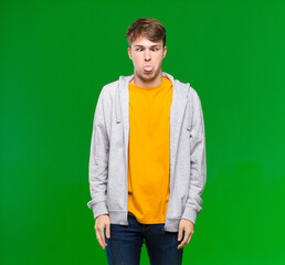 young blonde man looking goofy and funny with a silly cross-eyed expression, joking and fooling...