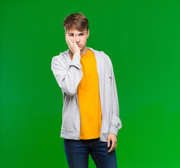 young blonde man feeling bored, frustrated and sleepy after a tiresome, dull and tedious task,...