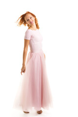 A beautiful young woman stands in the wind, the wind moves her c