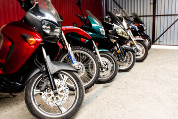 Colored sports, road beautiful bikes in a motor show. Many motorcycles parked in a store. Sale of...