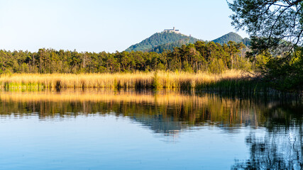 Medieval Castle Bezdez on the top of Bezdez Mountain. Reflected in Brehynsky Pond, Czech Republic
