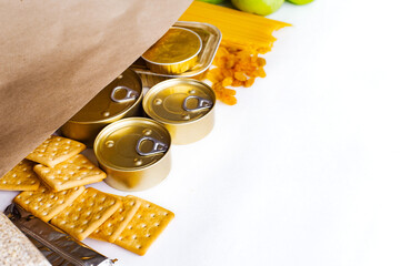 Food delivery, Donation. Food supplies crisis food stock for quarantine isolation period on white background. Pasta, canned food, apples, oil, crackers.