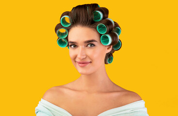 Pretty Housewife With Hair Curlers Smiling Posing Over Yellow Background