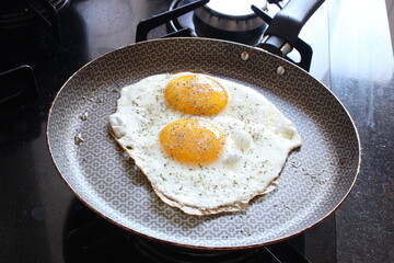 Fried Eggs with Oregano on Fridge Pan