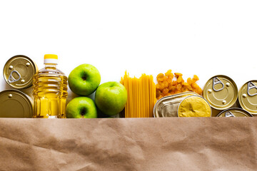 Food delivery, Donation. Food supplies crisis food stock for quarantine isolation period on white background. Pasta, canned food, apples, oil, crackers.