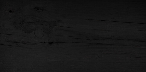 Background of black plank surface with natural pattern. Panoramic old black plank texture. Close-up detail of scratched wood surf 