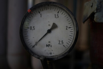 Old vintage steel steam boiler gauge in boiler house                              