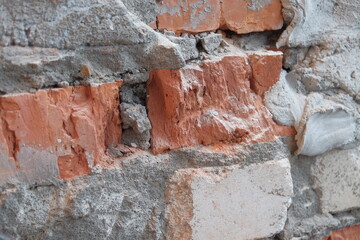 The old damaged brick wall. Close up view.