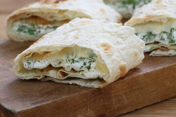 Lavash roll stuffed with cheese and herbs