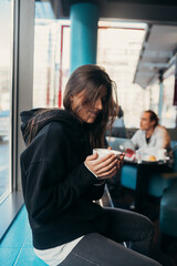 Close up portrait of pretty female drinking coffee.