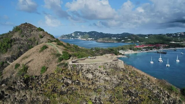 Aerial shooting of Fort Rodney on a mountain, an island, a city, mountains and yachts at at Rodney Bay, Saint Lucia