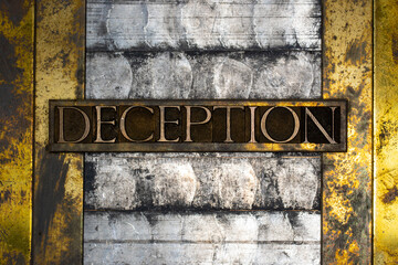 Photo of real authentic typeset letters forming Deception text on vintage textured silver grunge...
