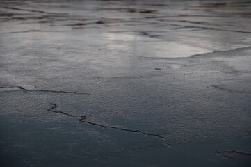 Sky reflection on wet concrete after rain with cracks