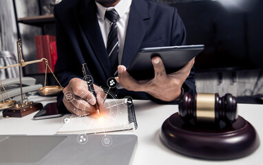 Concepts of Law and Legal services.	Lawyer businessman working with digital tablet at office.