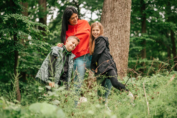 Fototapeta premium Happy family having fun together in forest