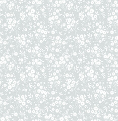 Floral pattern. Pretty flowers on light gray background. Printing with small white flowers. Ditsy print. Seamless vector texture. Spring bouquet.