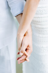 Hands of newlywed couple together. Wedding day. Man and woman hands holding together, wedding photo