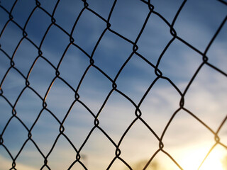 Naklejka premium Fence at sunset I