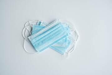 Medical protective masks on a gray background. Disposable 3-ply medical mask to cover the mouth and nose to prevent coronavirus. Coronavirus quarantine. Antivirus medical mask for protection covid-19.