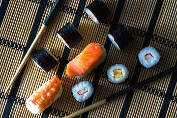Healthy traditional japanese Sushi set nigiri and rolls with chopsticks.