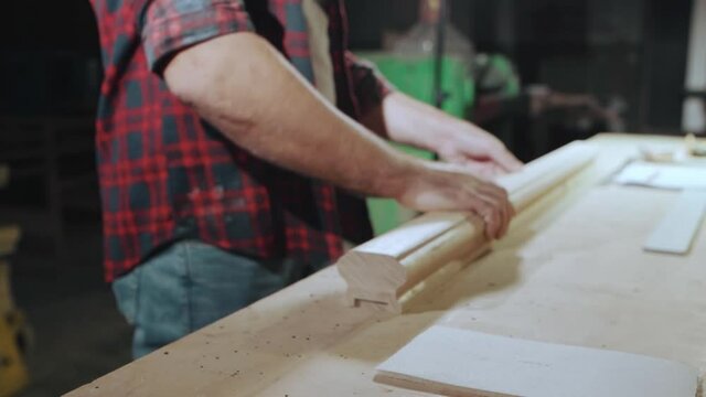 Hand glides over a wooden product, slow motion