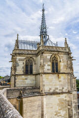 Fototapeta na wymiar View of Amboise Saint Hubert gothic chapel. Saint Hubert Chapel houses the tomb of the Renaissance Man Leonardo da Vinci. Amboise, Valley of the river Loire. France.