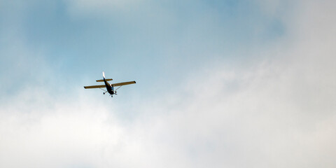 Small passenger plane flying in the blue sky